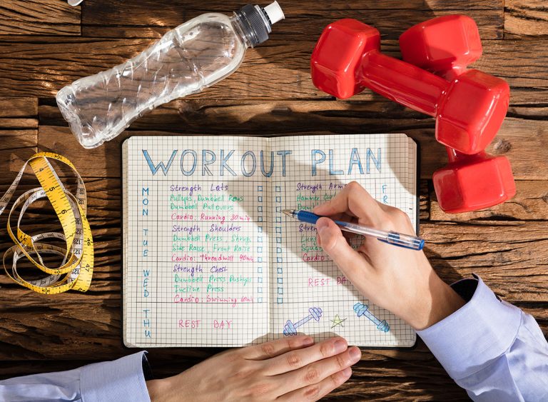 Elevated,View,Of,A,Person,Making,Note,Of,Workout,Plan