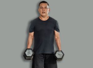 Middle-aged,Southeast,Asian,Man,Carries,Two,Dumbbells,In,A,Farmerís