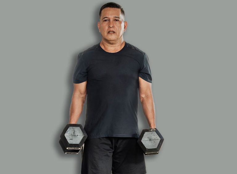 Middle-aged,Southeast,Asian,Man,Carries,Two,Dumbbells,In,A,Farmerís