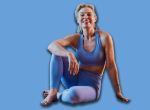 Happy,Mature,Woman,Wearing,Sportswear,Sitting,On,Yoga,Mat,In