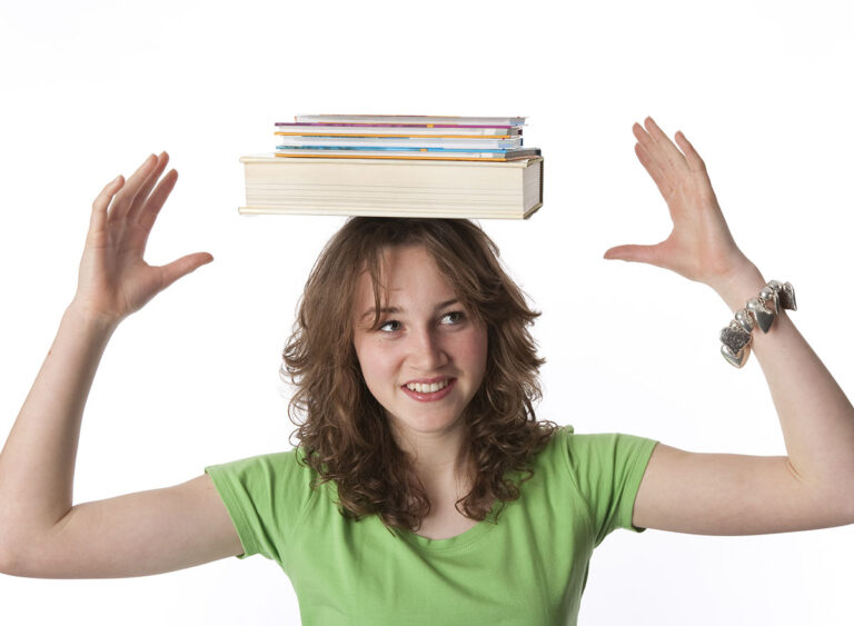 Teenage,Girl,Is,Carrying,Text,Books,On,Her,Head,At