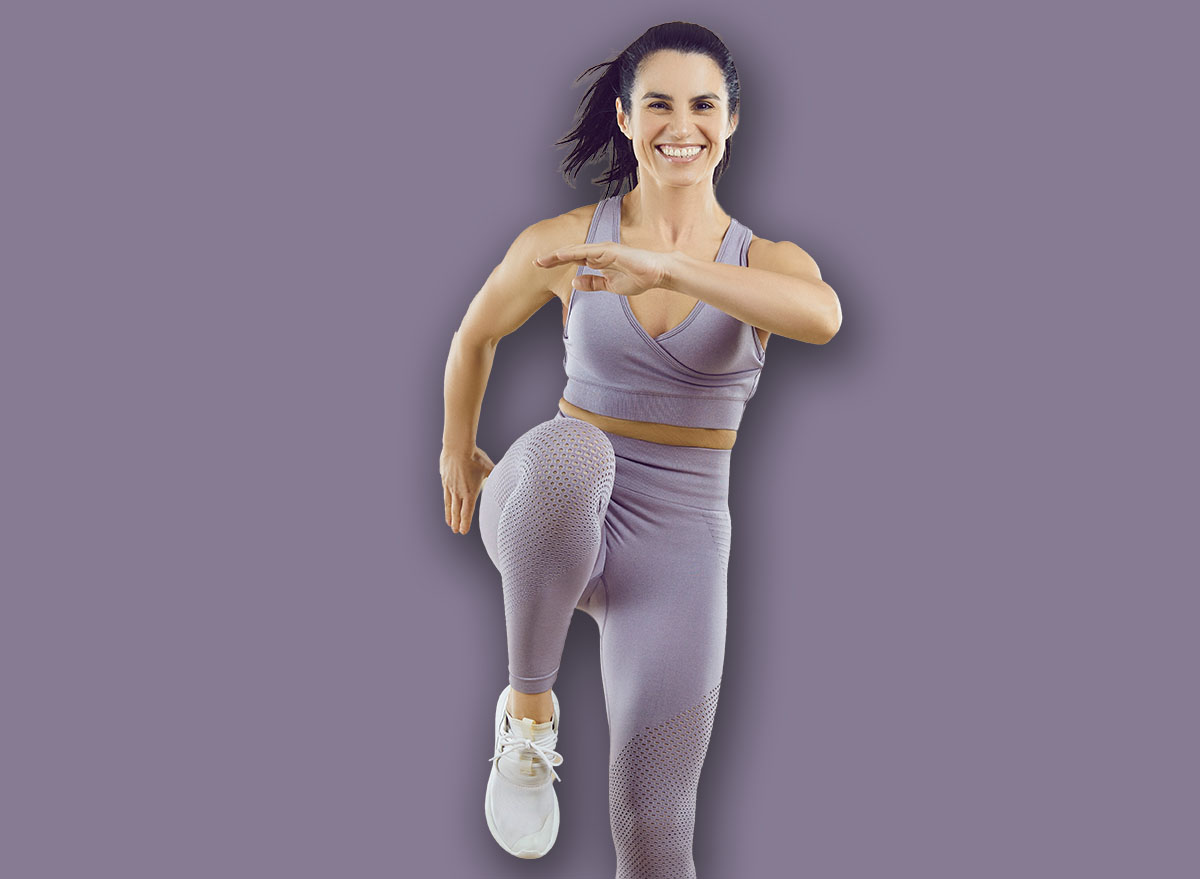 Cheerful,Sportswoman,Performs,Sport,Jumps,Raising,Her,Knees,High,On