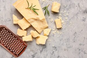 Pieces,Of,Tasty,Parmesan,Cheese,On,Grunge,Background