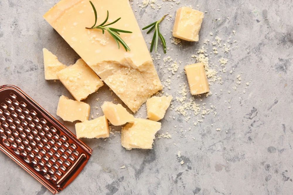 Pieces,Of,Tasty,Parmesan,Cheese,On,Grunge,Background