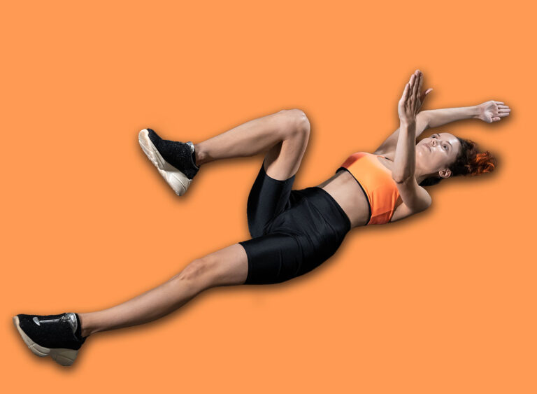 Young,Woman,Exercising,Dead,Bug,With,Personal,Trainer,In,Gym