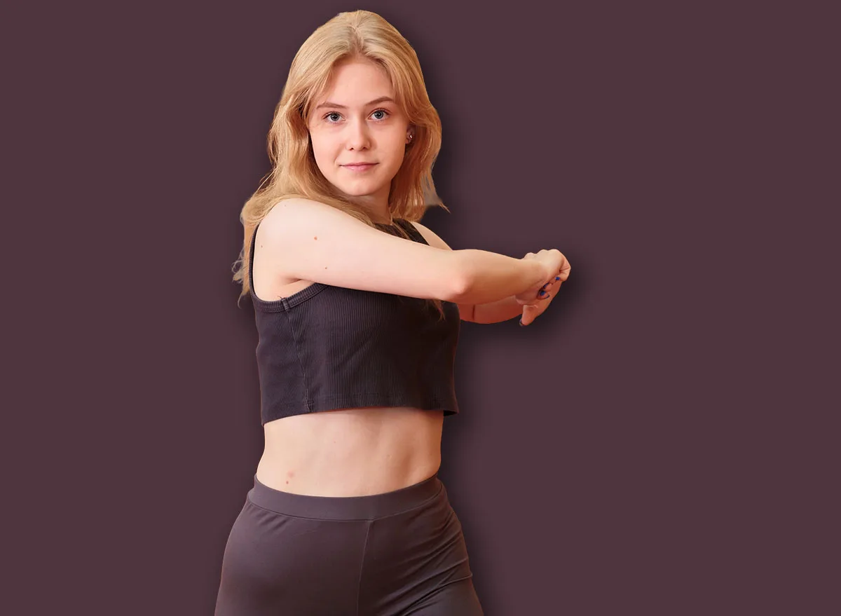 Fit,Woman,Doing,Standing,Torso,Twist,Stretch,With,Arms,Extended