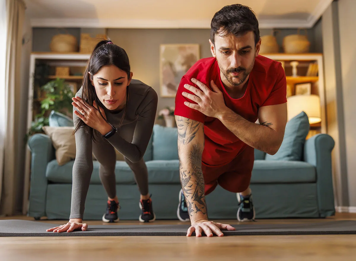Active,Fit,Couple,In,Sportswear,Doing,Plank,Shoulder,Taps,Exercise