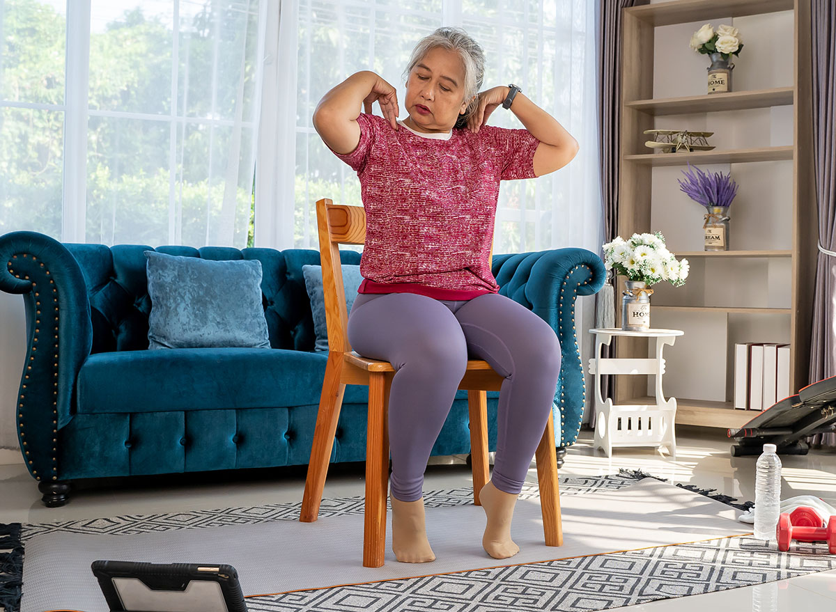 Senior,Woman,Sitting,On,A,Wooden,Chair,And,Slowly,Rotate