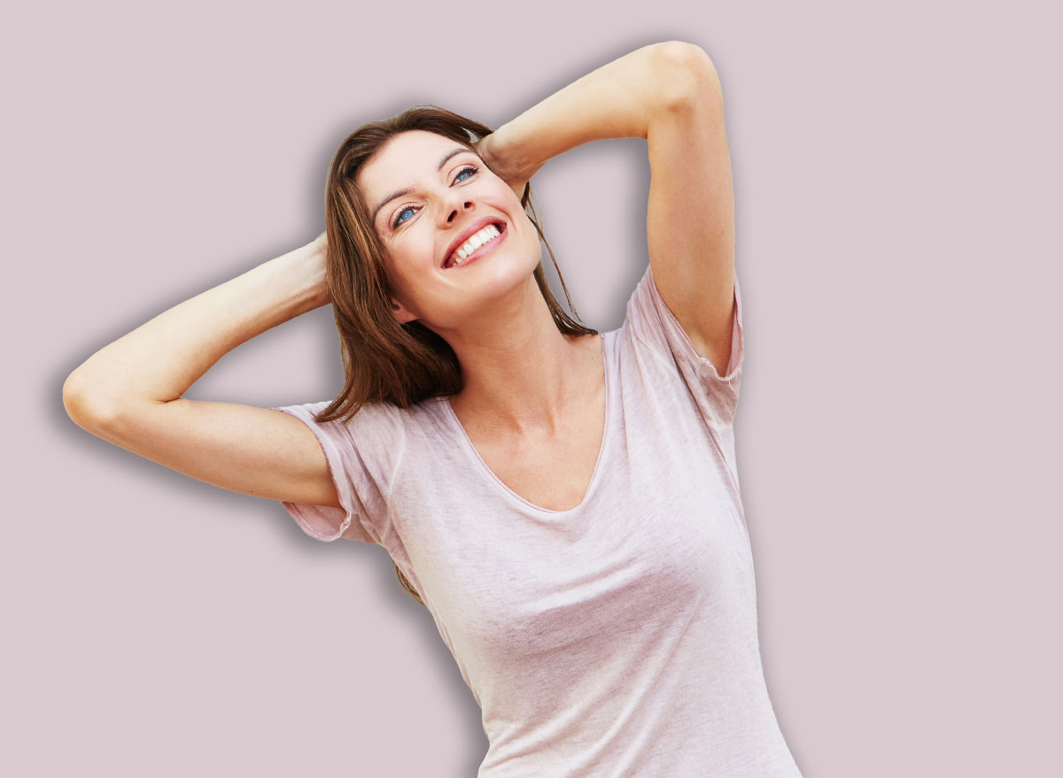 Portrait,Of,Attractive,Female,Model,Posing,Against,White,Wall