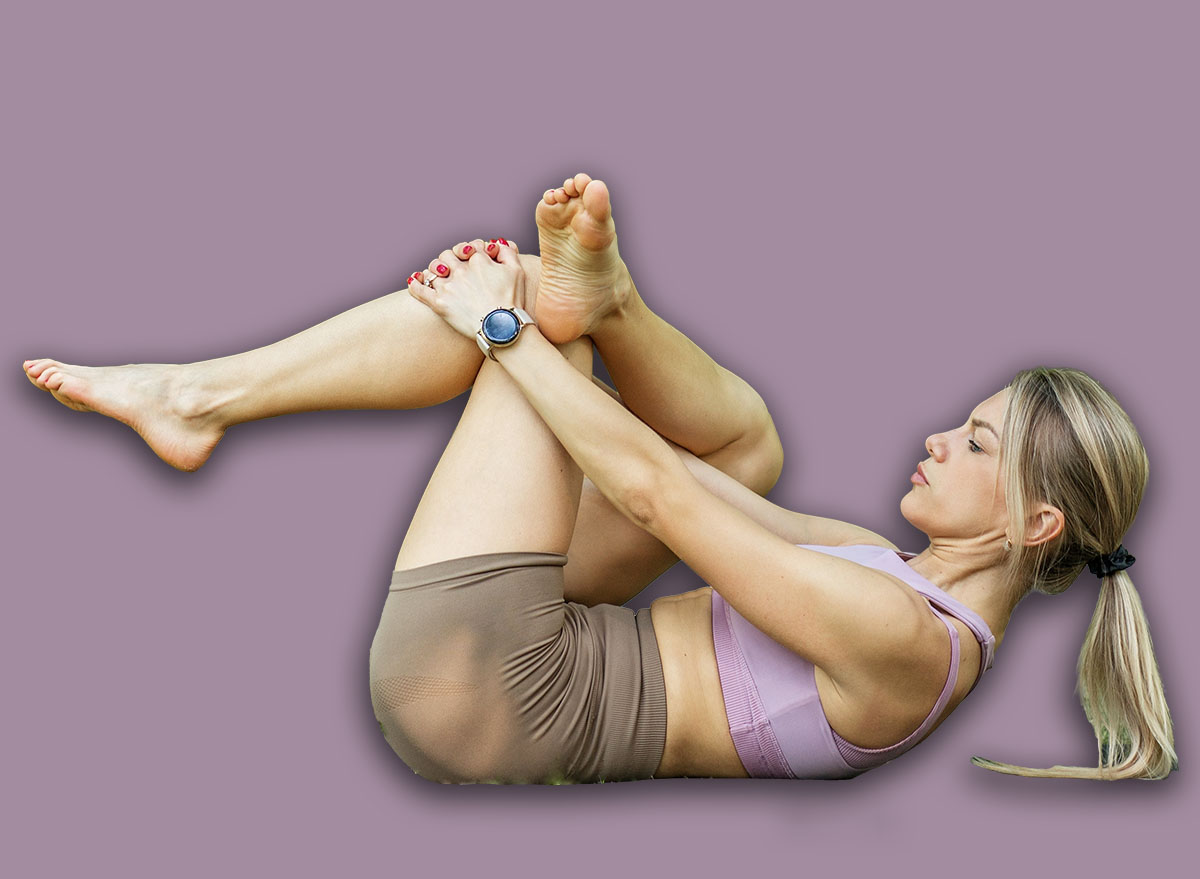 Young,Fit,Woman,Performing,A,Figure,Four,Stretch,On,Her