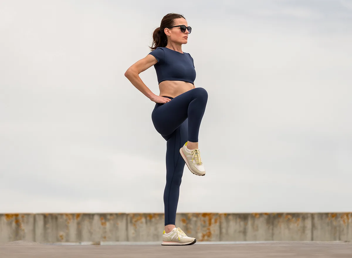 Sporty,Woman,Stretching,Leg,Muscles,With,Standing,Single,Knee,To