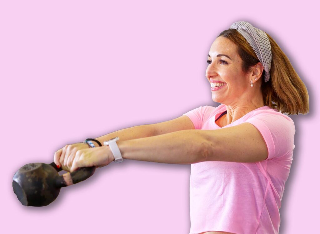 Women,Lifting,Kettlebells,During,A,Fitness,Class,,Building,Strength,And