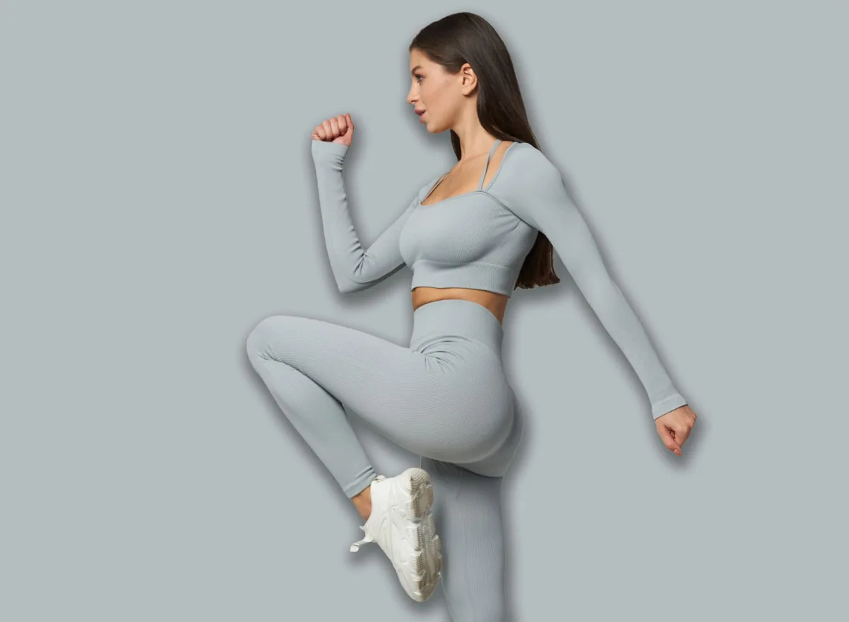 Young,Woman,In,Gray,Workout,Attire,Performing,A,High-knee,Exercise,