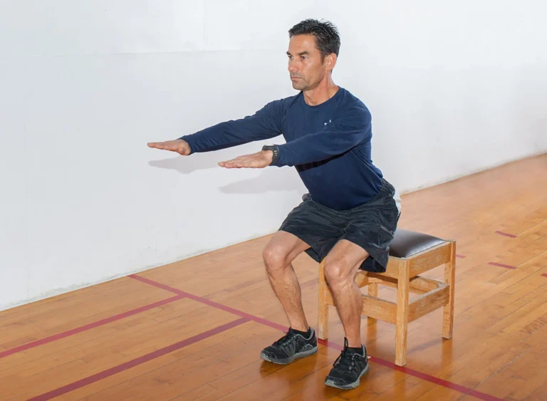 Middle,Age,Man,Demonstrates,Bench,Squat,Strength,Exercise.