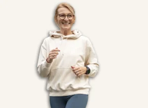 Senior,Woman,In,Activewear,Jogging,Through,A,Modern,Urban,Neighborhood,