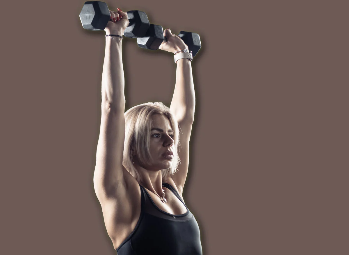 Athletic,Woman,In,Sportswear,Trains,Shoulder,Muscles,With,Heavy,Dumbbells