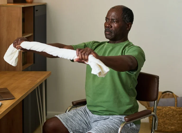 Senior,Black,Man,Sitting,On,Chair,Stretching,Arms,Forward,With