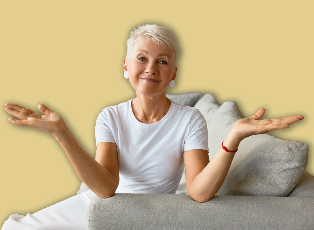Wise,Senior,Female,With,Calm,Smile,On,Couch,Throwing,Up