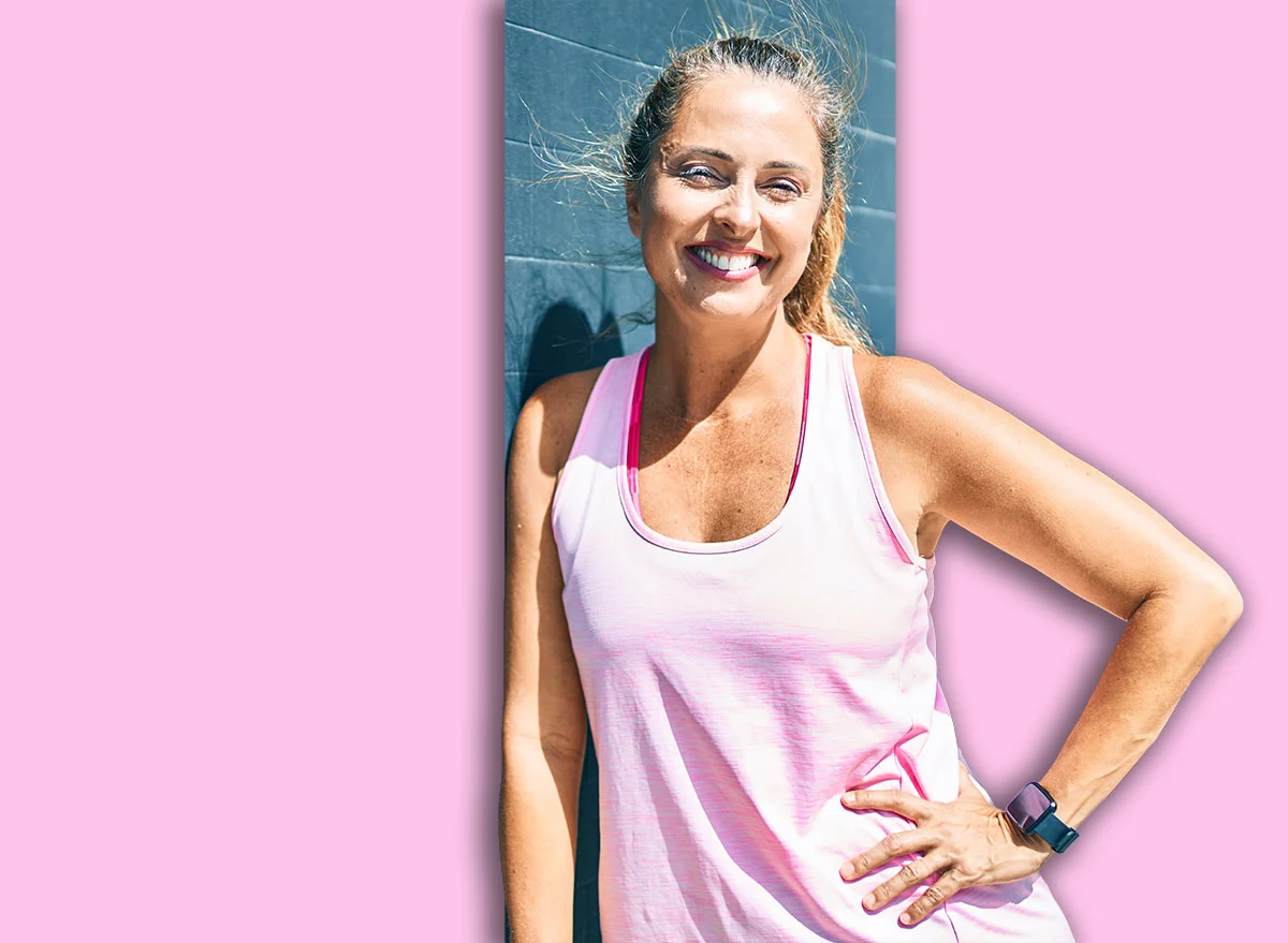 Middle,Age,Sportswoman,Smiling,Happy,Leaning,On,The,Wall,At