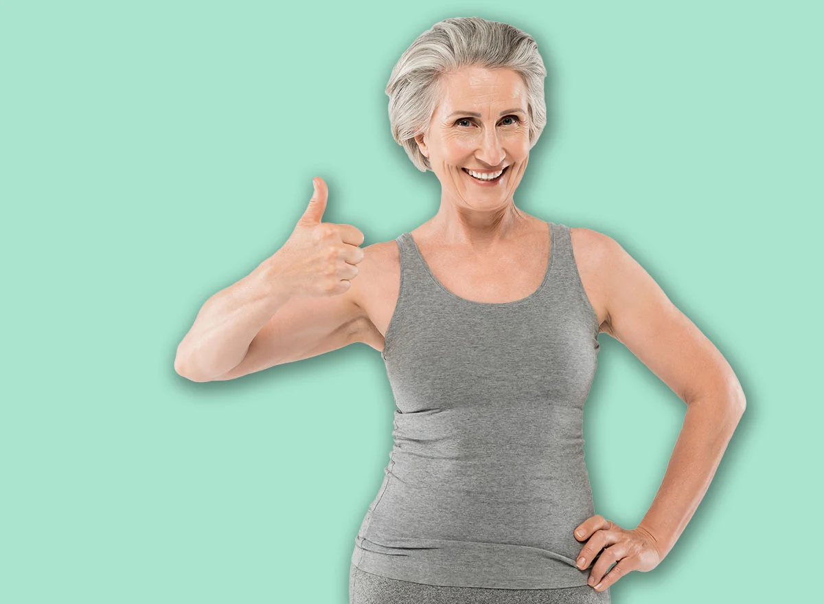 Cheerful,And,Retired,Woman,In,Sportswear,Posing,With,Hand,On
