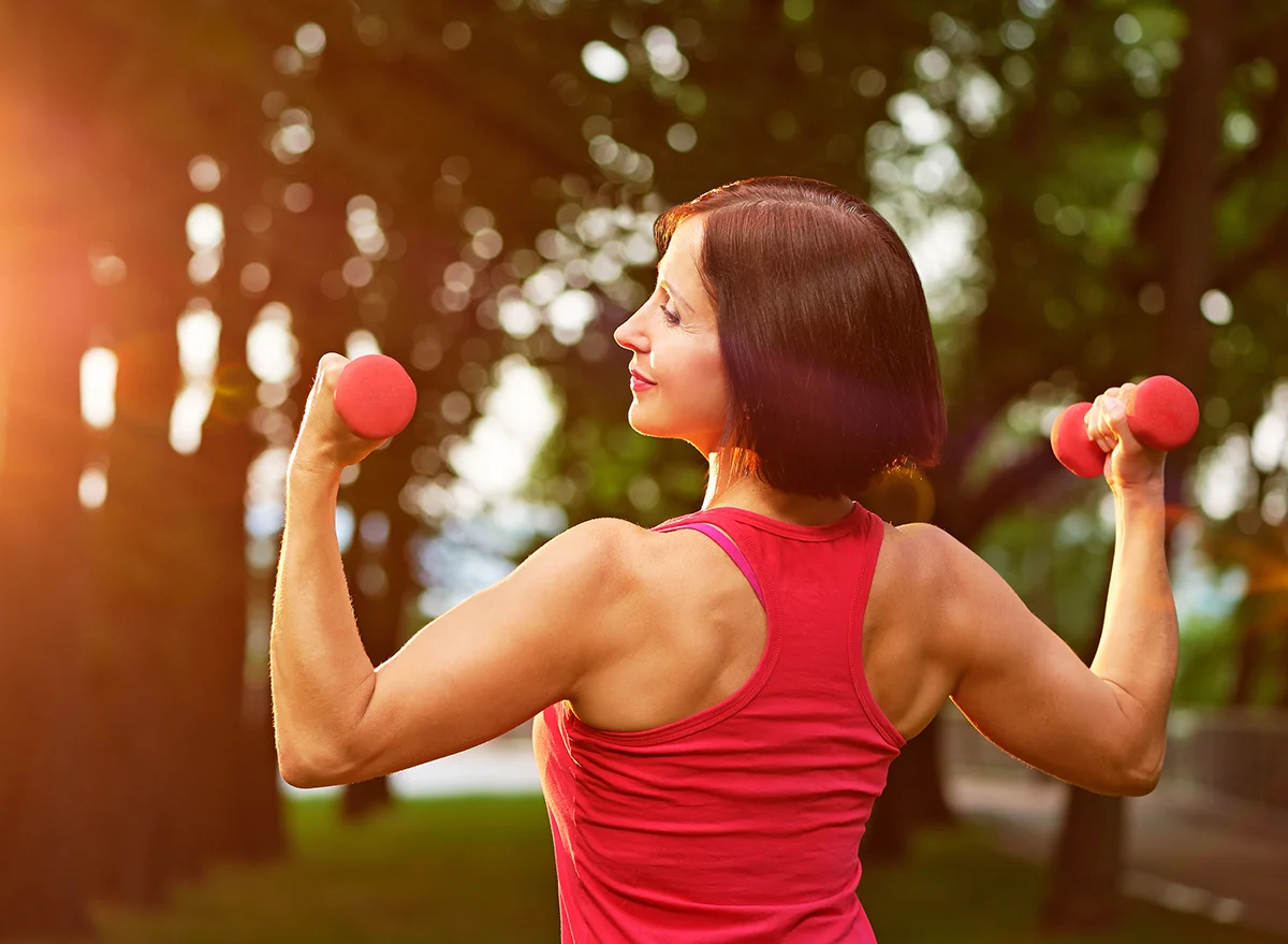 Aged,Woman,Working,Out,With,Small,Dumbbells,In,The,Park