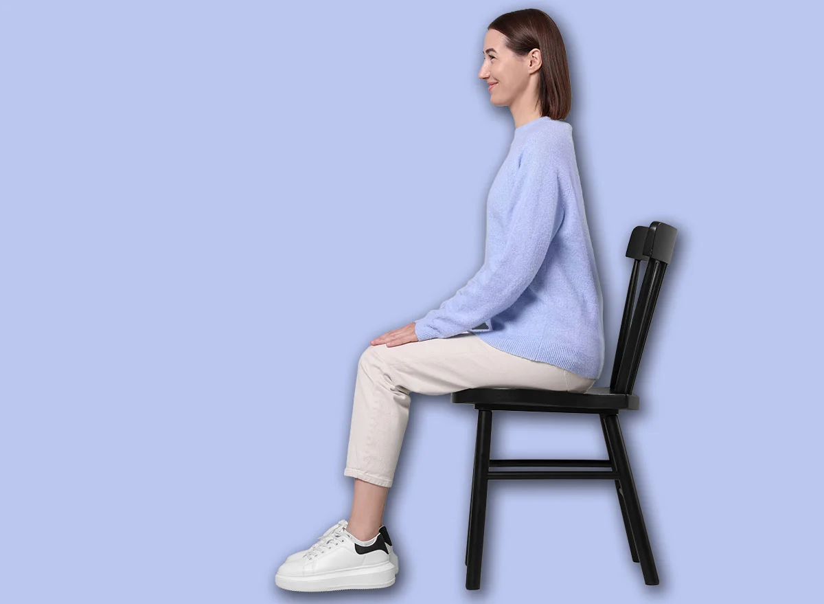 Woman,With,Good,Posture,Sitting,On,Chair,Against,Gray,Background
