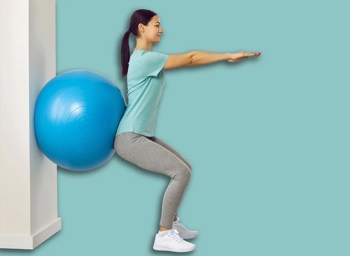 Fitness,Trainer,Helping,Young,Female,Patient,Do,Wall,Squats,With