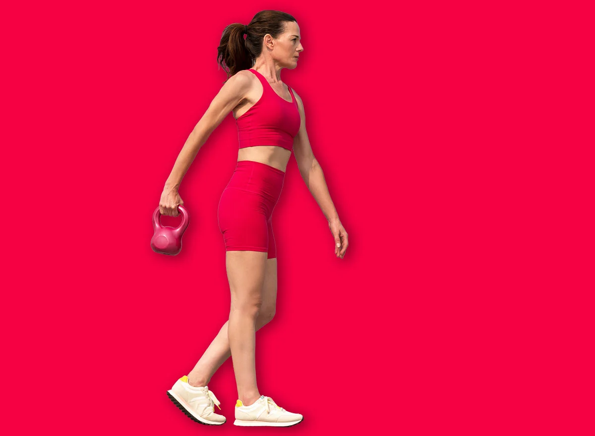 Sporty,Mid,Adult,Woman,Carrying,A,Kettlebell,Weight,,Training,Outdoors.