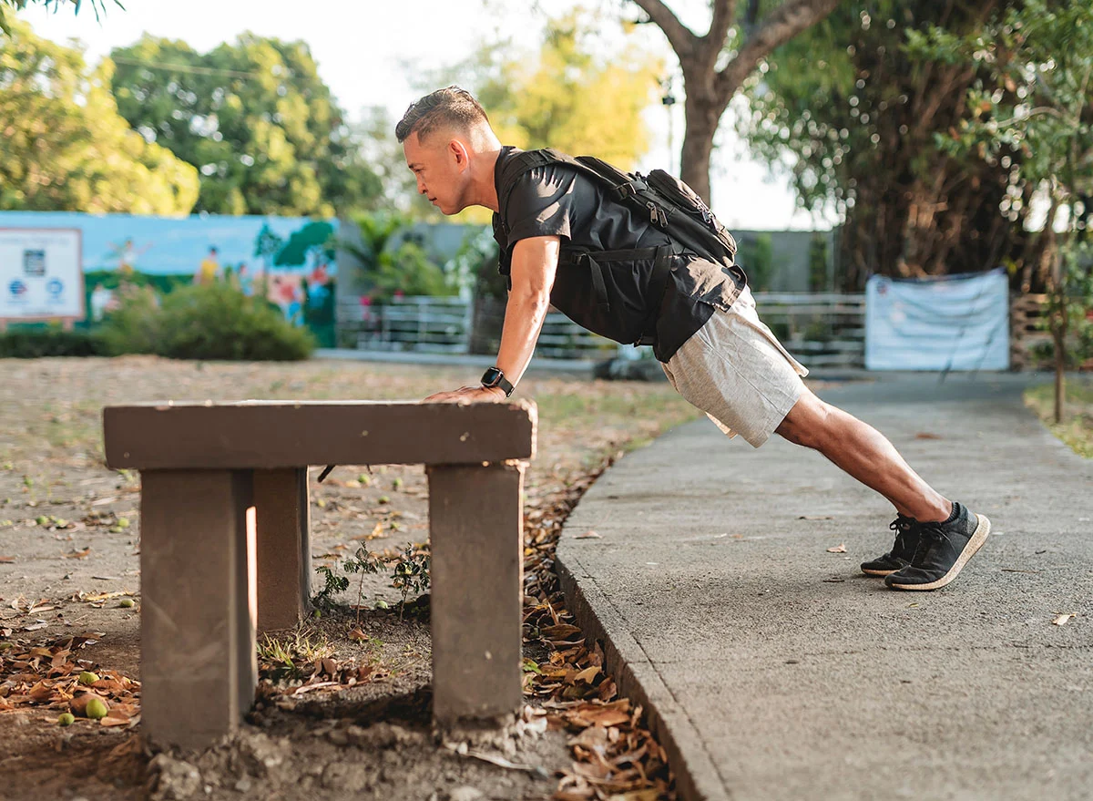 Middle,Aged,Southeast,Asian,Man,Doing,Incline,Pushups,On,A