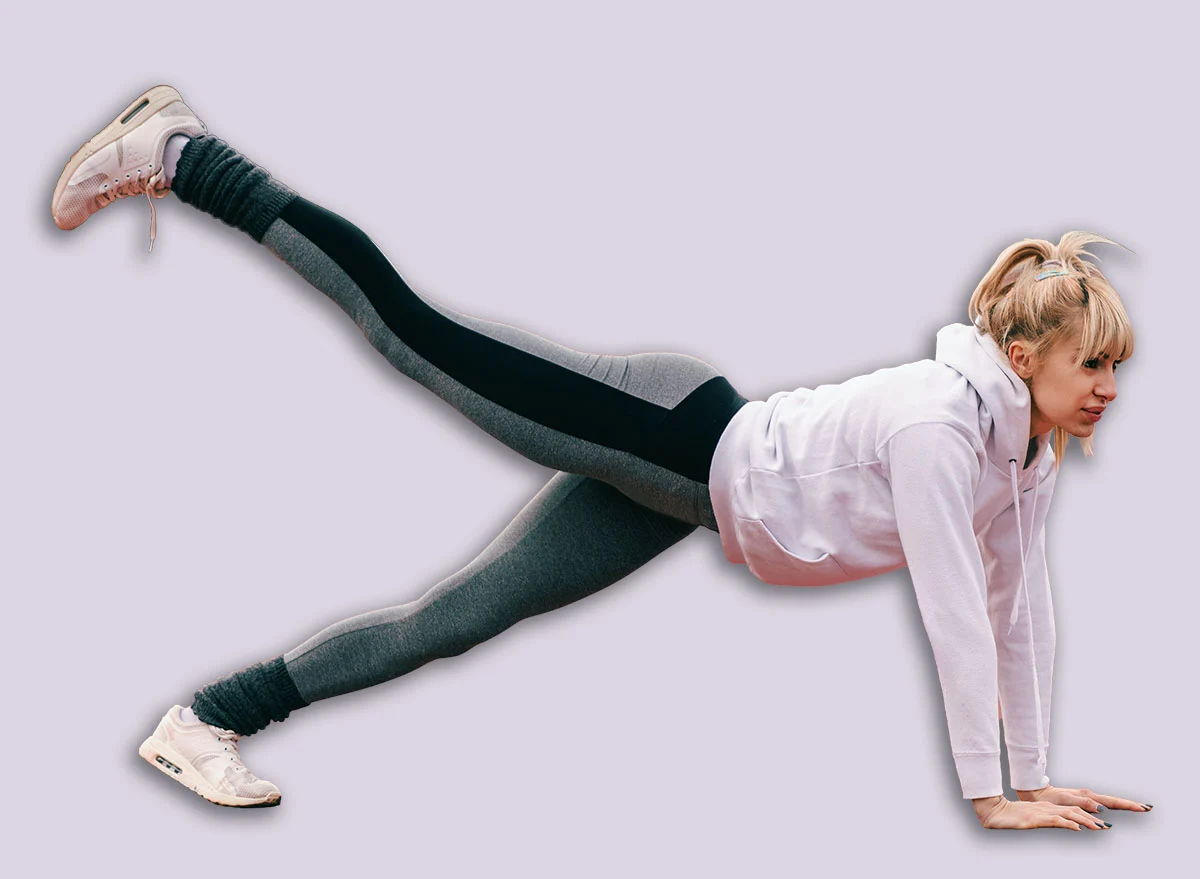 Beautiful,Caucasian,Blonde,Woman,Doing,Plank,Leg,Raises,On,The