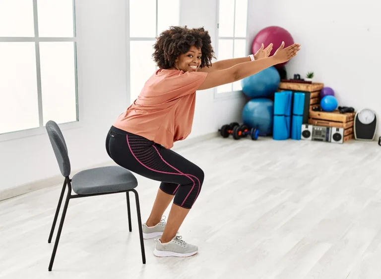 Young,African,American,Woman,Smiling,Confident,Stretching,At,Sport,Center