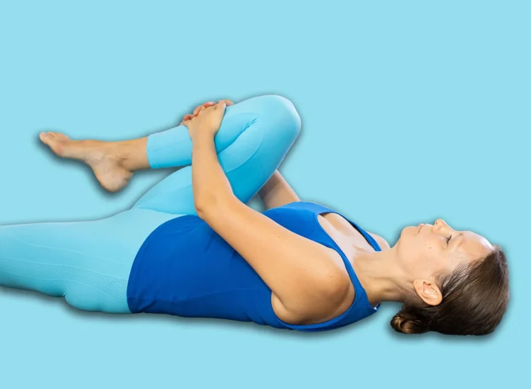 Calm,Middle-aged,Woman,Practicing,Knee,To,Chest,Pose,Of,Yoga