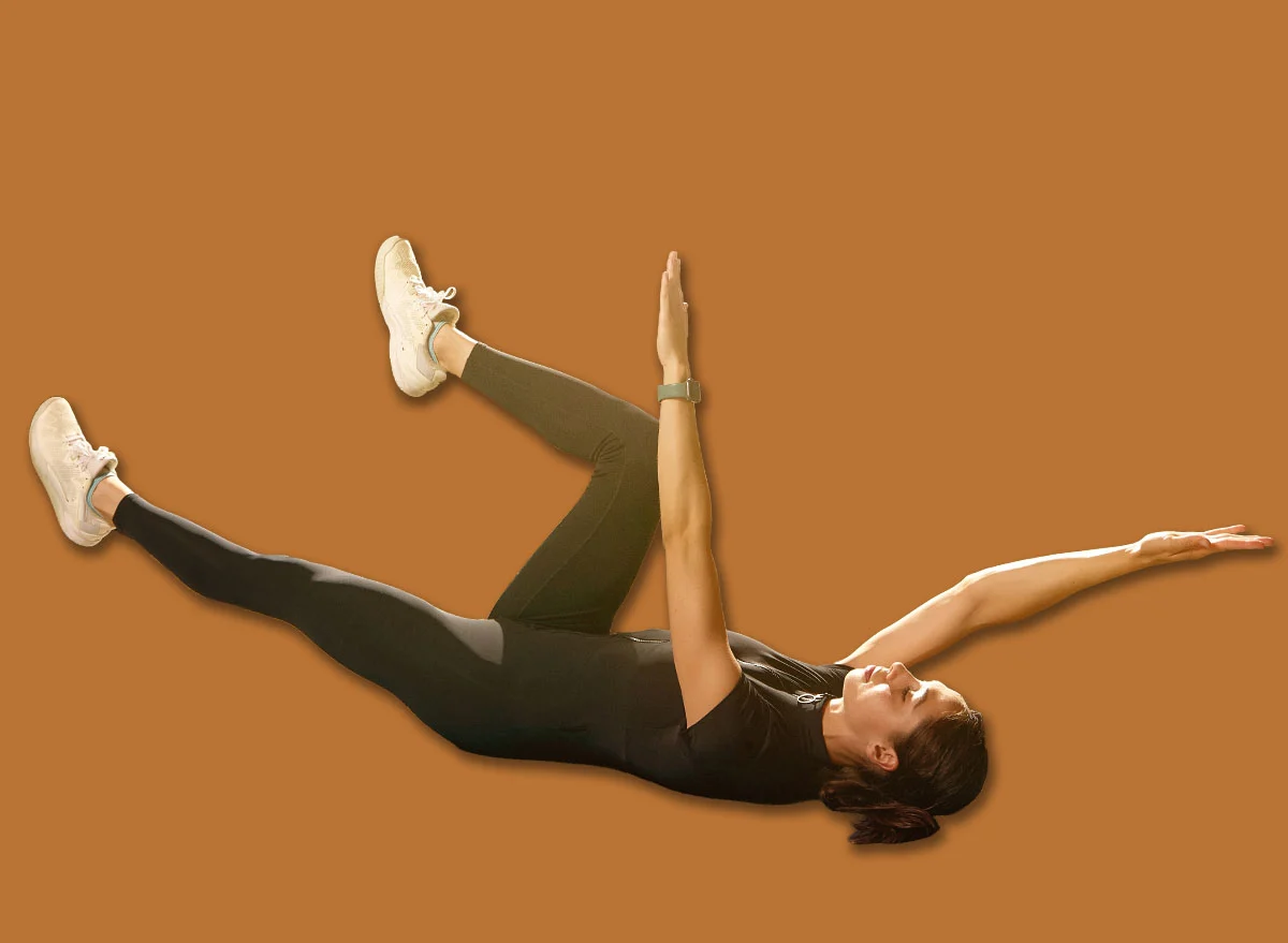 Woman,Doing,Dead,Bug,Core,Exercise,On,Mat,Beside,Laptop